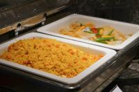 two trays of rice and vegetables in an oven at Paco Hotel Bei Jing Road Tuan Yi Da Metro Guangzhou in Guangzhou