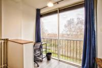a room with a desk and a large window at La Casa Will - Family flat for 8 in Hérouville-Saint-Clair