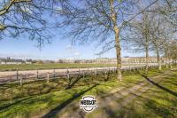 a fence in a field with trees in the foreground at La Casa Will - Family flat for 8 in Hérouville-Saint-Clair