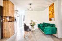 a living room with a green couch and a table at La Casa Will - Family flat for 8 in Hérouville-Saint-Clair