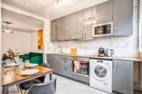 a kitchen with a table and a washing machine at La Casa Will - Family flat for 8 in Hérouville-Saint-Clair