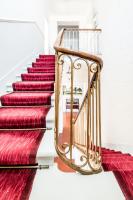 a set of stairs with red rugs at Gîte Château de Seguin in Lignan-de-Bordeaux