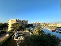 a view of a city with a river and buildings at Appartement studio vue sur la Marina in Canet-en-Roussillon