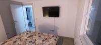 a room with a tv on a wall with a bed at Villa SHAMS in Travnik