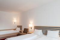 A bed or beds in a room at Gästehaus Brugger
