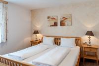 A bed or beds in a room at Gästehaus Brugger