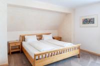 A bed or beds in a room at Gästehaus Brugger