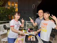 a group of people standing around a table with a cake at I Leisure B&amp;B in Yuanshan