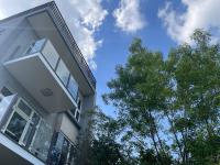 a building with trees in front of a blue sky at I Leisure B&amp;B in Yuanshan