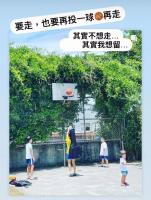 a woman playing basketball with three children on a court at I Leisure B&amp;B in Yuanshan