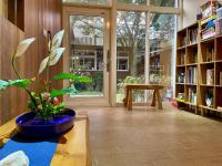 a library with a large window and a plant on a table at I Leisure B&amp;B in Yuanshan