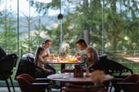 a group of people sitting at a table in a restaurant at Stara Pravda Villas in Bukovel