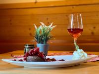 a plate of food and a glass of wine on a table at Ölmühle Eberstedt in Eberstedt