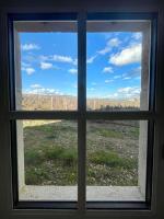 a window with a view of a field through it at Domaine Clos Carron Studio 2 personnes L&#39;Olivier in Saint-Amour-Bellevue