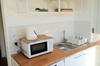 a microwave sitting on a counter next to a sink at Appartement de charme à Digoin #2 in Digoin