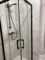 a shower with glass doors in a bathroom at Studio 50 m de la mer - Centre - Vue mer partielle in Nice