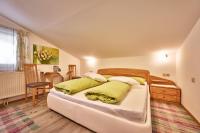 a bedroom with a large bed with yellow pillows at Ferienwohnung Familie Wieser in Altenmarkt im Pongau