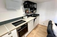 a small kitchen with a sink and a microwave at Maison et appartement attenant pour 10 personnes avec terrasse, cour et parking in Pau