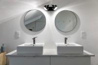 a bathroom with two sinks and a mirror at Maison et appartement attenant pour 10 personnes avec terrasse, cour et parking in Pau