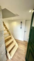 a wooden staircase in a room with a door at Maison et appartement attenant pour 10 personnes avec terrasse, cour et parking in Pau