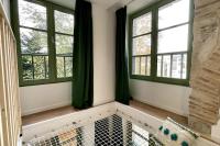 a room with three windows and a bathtub in front at Maison et appartement attenant pour 10 personnes avec terrasse, cour et parking in Pau