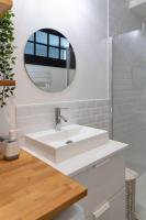 a white bathroom with a sink and a mirror at Maison et appartement attenant pour 10 personnes avec terrasse, cour et parking in Pau