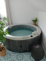 a bath tub in a room with plants at Ama&#39;s Sweet home in Saint-Hubert