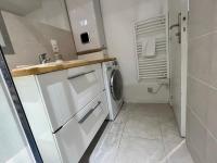 a small bathroom with a washer and dryer at Le 46 Magenta - Grand Duplex en hypercentre in Poitiers