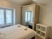 a bedroom with a white bed and a mirror at Le 46 Magenta - Grand Duplex en hypercentre in Poitiers
