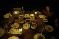 a table topped with plates of food and candles at Burhan Wilderness Camps in Bhurkīā