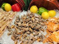 a bunch of insects on ice next to some fruit at Sheraton Zhoushan Hotel in Zhoushan