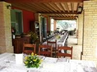 una fila di tavoli e sedie su un patio di Agriturismo Rosso di Sera a Cugnoli