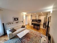 a living room with a couch and a kitchen at Cosy Appartement in Paris 15th - Convention Center in Paris