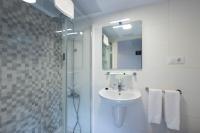 a white bathroom with a sink and a mirror at Hotel Tugasa Arco de la Villa in Zahara de la Sierra