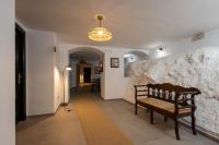 a hallway with a bench and a wall with a light at Hotel Tugasa Arco de la Villa in Zahara de la Sierra