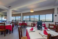 a restaurant with tables and chairs with red napkins on them at Hotel Tugasa Arco de la Villa in Zahara de la Sierra