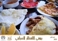 Una mesa con platos de comida para el desayuno. en Al-Sadier Place Hotel & Restaurant, en Baghdād