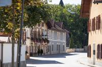 an empty street in a town with buildings at Hotel Garni Löwen in Silz