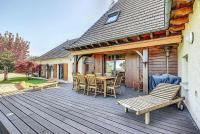 a wooden deck with a table and chairs on it at Gîte de France Bayat 4 épis - Gîte de France 5 personnes 354 in Varetz