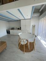 a kitchen with a table and chairs in a room at Appartement coeur ville - Casa Riviera Mimosa in Sainte-Maxime