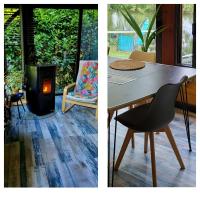 a table and a chair and a wood stove at Maison de vacances: chez Nirina in Mortagne-sur-Sèvre