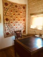a table in a room with a tapestry on the wall at Manoir de Pimelles-Bourgogne-Chablis-2h15 Paris 