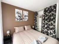 a bedroom with a large bed with two pictures on the wall at Chez NAYA- Proximité Paris- Métro 8 in Alfortville