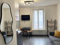 a living room with a couch and a table and a mirror at Chez NAYA- Proximité Paris- Métro 8 in Alfortville