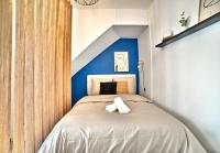 a bedroom with a bed with a blue accent wall at L&#39;escapade Fourasine - Heart of Fouras in Fouras