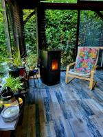 a screened in porch with a wood burning stove at Maison de vacances: chez Nirina in Mortagne-sur-Sèvre