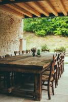 een houten tafel met stoelen eromheen bij Asolo Norah's Hill Agri Rooms in Caenere