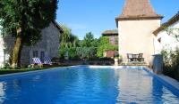 a swimming pool in the yard of a house at Manoir du Bois Mignon in Le Fleix