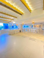 a large banquet hall with white tables and chairs at Hotel Cartagena Premium in Cartagena de Indias