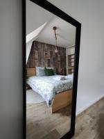 a mirror reflection of a bedroom with a bed at Appartement NATURA 2 chambres in Vitré